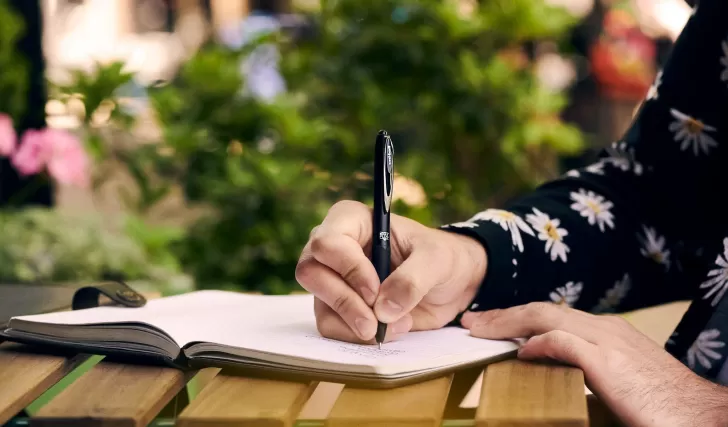 person writing in a journal